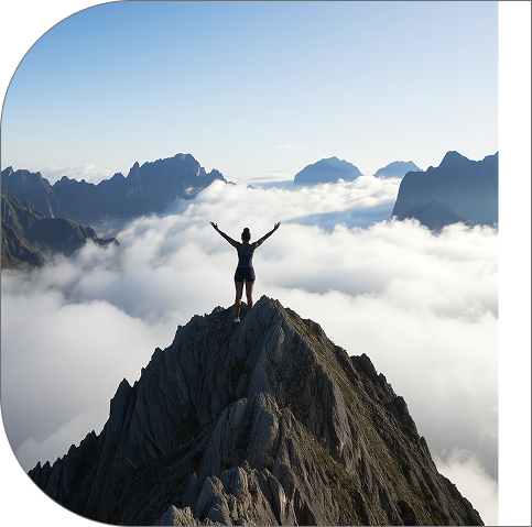 Person standing on mountain with arms raised